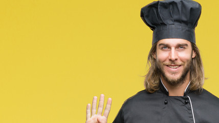 Young handsome cook man with long hair over isolated background showing and pointing up with...