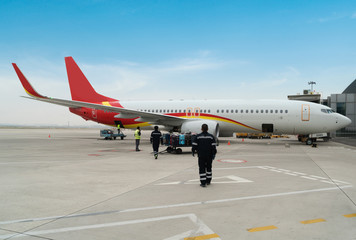 A passenger plane being serviced by ground services before next takeoff