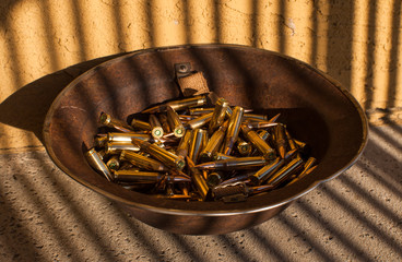 Rusty helmet full of rifle ammunition