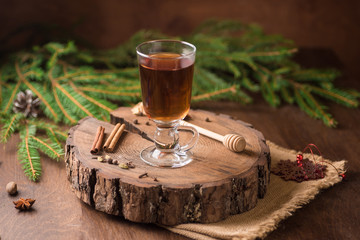 Spiced Apple Cider Mulled Sangria in glass cup on wooden background. Hot drinks for Christmas.
