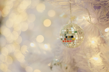 Fototapeta na wymiar White Christmas decoration with balls on fir branches with blurred background