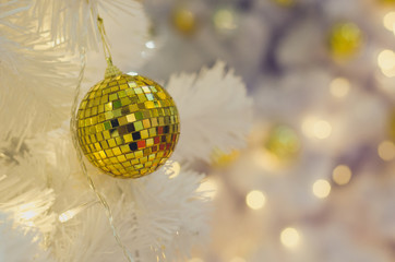White Christmas decoration with balls on fir branches with blurred background