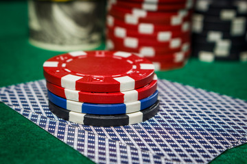 Poker chips on the game cards on the poker table close up