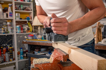 the electric sander on a wood backgroundshavings
