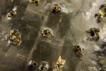 grunge background many shells bullets surface of an old broken pierced bulletproof vest rescue safety