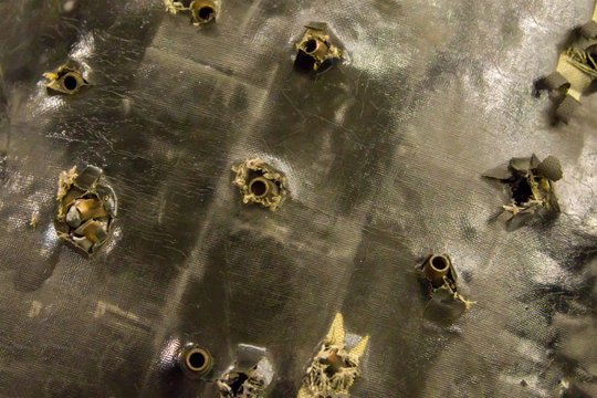 Grunge Background Many Shells Bullets Surface Of An Old Broken Pierced Bulletproof Vest Rescue Safety