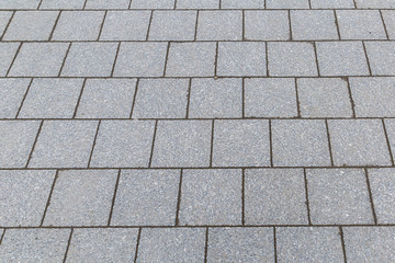 gray tiles square blocks part of the city square smooth surface with lines of a set of stones site...
