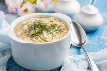 Tasty mushroom soup with noodles on a wooden table.