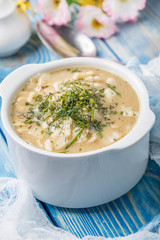 Tasty mushroom soup with noodles on a wooden table.