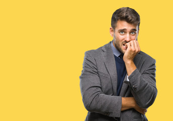 Young handsome business man over isolated background looking stressed and nervous with hands on mouth biting nails. Anxiety problem.