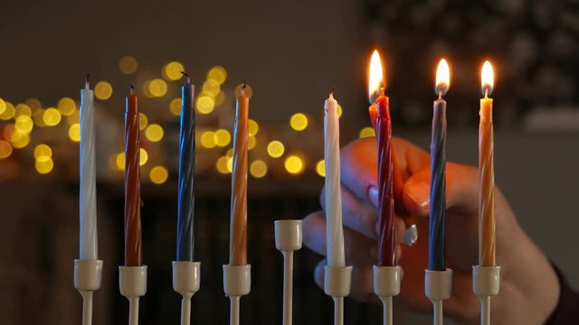 Close-up of man light hanukkah menorah