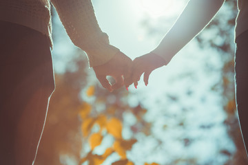 Romantic couple holding hands together