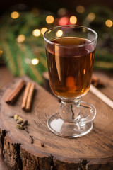 Spiced Apple Cider Mulled Sangria in glass cup on wooden background. Hot drinks for Christmas.