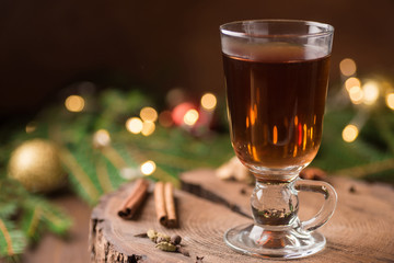 Spiced Apple Cider Mulled Sangria in glass cup on wooden background. Hot drinks for Christmas.