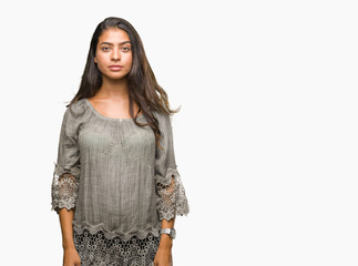 Obraz premium Young beautiful arab woman over isolated background with serious expression on face. Simple and natural looking at the camera.