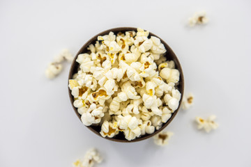Popcorn in wooden bowl isolated on white background. Top view.Selective focus.
