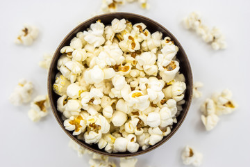 Popcorn in wooden bowl isolated on white background. Top view.Selective focus.