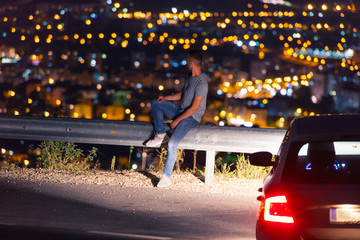 Man looking above the city in the night.