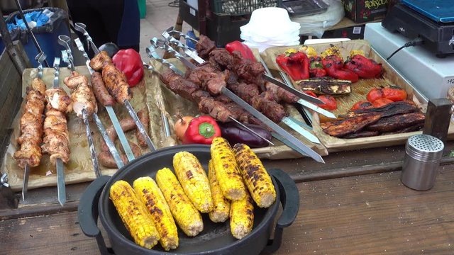 Kherson, Ukraine - 27th of May, 2017:  4K KhersON Food Festival - Grilled ear corn and meat with vegetables