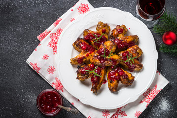 Baked chicken wings in cranberry sauce. 