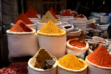 Baskets of fresh raw essential Indian spices, chili, coriander and turmeric powder, spice market in Jaipur, Rajasthan, India.	