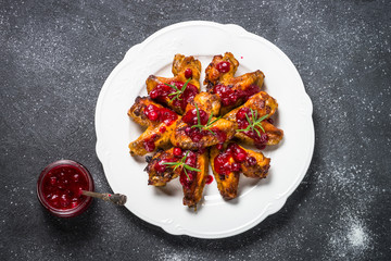 Baked chicken wings in cranberry sauce. 