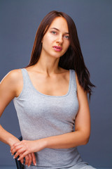 Obraz premium Closeup portrait of a beautiful young brunette woman in white t-shirt,