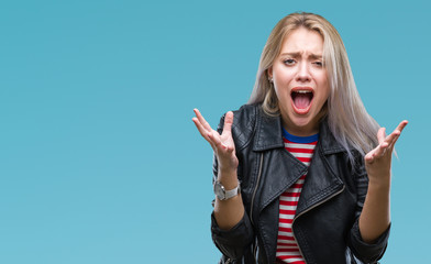 Young blonde woman wearing black jacket over isolated background crazy and mad shouting and yelling with aggressive expression and arms raised. Frustration concept.