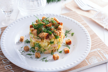 salad with smoked ham, corn, crackers on a white plate, horizontal