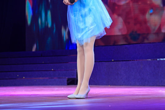 Ms dressed in blue skirt filar socks high heels