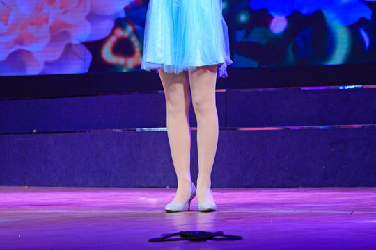 Ms dressed in blue skirt filar socks high heels