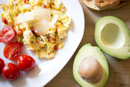 Healthy breakfast with  scramble eggs, vegetables and avocado