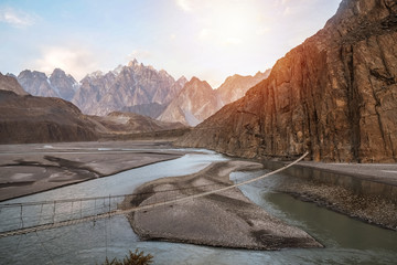 Landscape view of Hussaini hanging bridge above Hunza river, surrounded by mountains. Gojal, Gilgit...