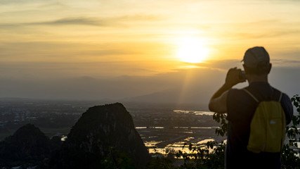 Tourist staying on the top of mountain and taking a photos of Marble mountains and beautiful Da...