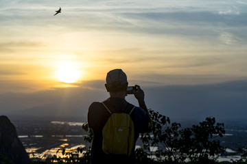 Tourist staying on the top of mountain and taking a photos of Marble mountains and beautiful Da...