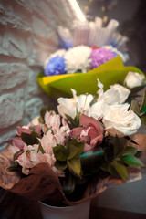 Rich bunch of pink peonies and lilac eustoma roses flowers, green leaf in glass vase. Fresh spring bouquet. Summer Background