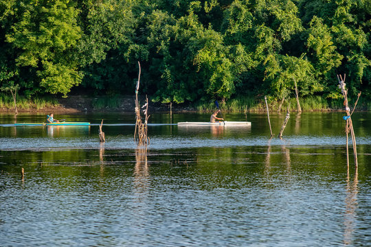 Novi Sad, Serbia - August 04, 2018: Danube island (&Scaron;odro&scaron;) near Novi Sad, Serbia. Man in kayak paddling on river.