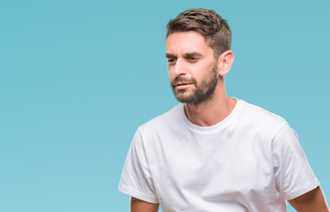 Obraz premium Young handsome man over isolated background with hand on stomach because nausea, painful disease feeling unwell. Ache concept.
