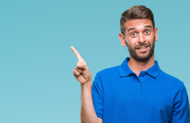 Young handsome man over isolated background with a big smile on face, pointing with hand and finger...
