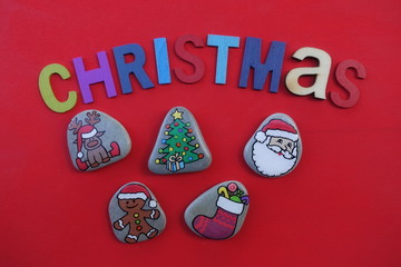 Christmas composition with colored stones and wooden letters over a red board