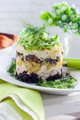 Chicken and prune salad garnished with cucumber and greens, selective focus