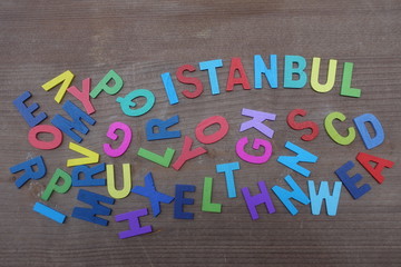 Istanbul, turkish city name composed with colored wooden letters over a brown wooden board