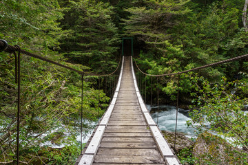 Fototapeta na wymiar Suspension wooden footbridge in Nahuel Huapi National Park, Patagonia, Argentina