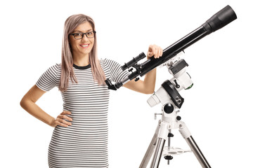 Young woman leaning on a telescope