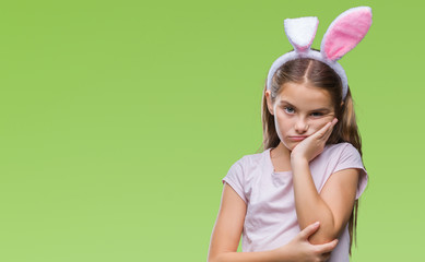 Obraz na płótnie Canvas Young beautiful girl wearing easter bunny ears over isolated background thinking looking tired and bored with depression problems with crossed arms.