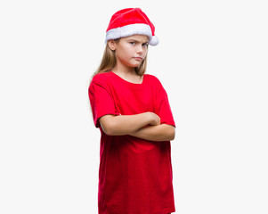 Young beautiful girl wearing christmas hat over isolated background skeptic and nervous, disapproving expression on face with crossed arms. Negative person.