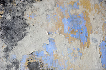 Beautiful colors layers of an outdoor plaster wall showing several times of wall repairing. Each...