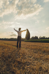 Businessman celebrating his achievement outside in autumn field
