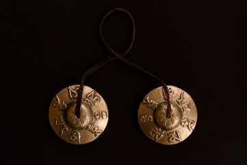 Singing Tibetan spiritual bells for mantra singing and meditation. Copper karatal on a leather...