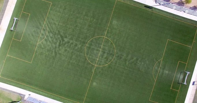 Aerial  view of soccer football green synthetic artificial turf grass field in spors arena in Los Angeles, California, 4K